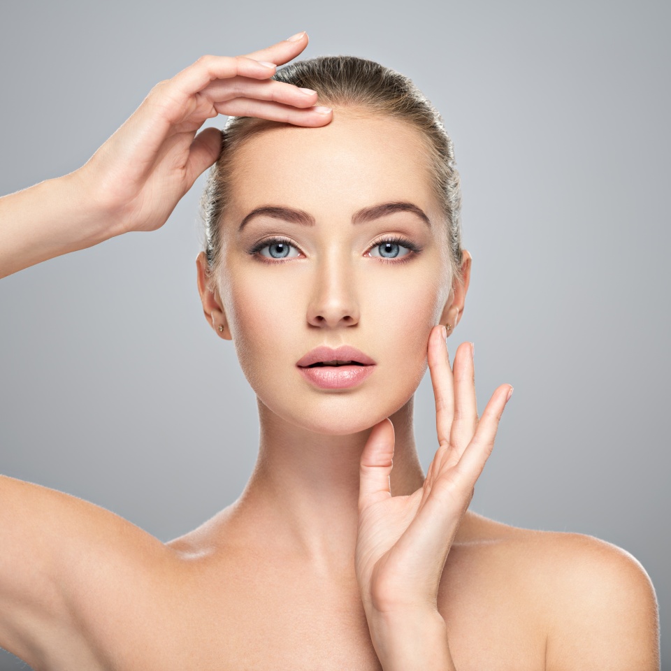 Beautiful face of young caucasian woman with perfect health clean skin. Skin care treatment. Portrait of an Attractive girl with blue eyes, closeup. Pretty and sexy female with stunning look.