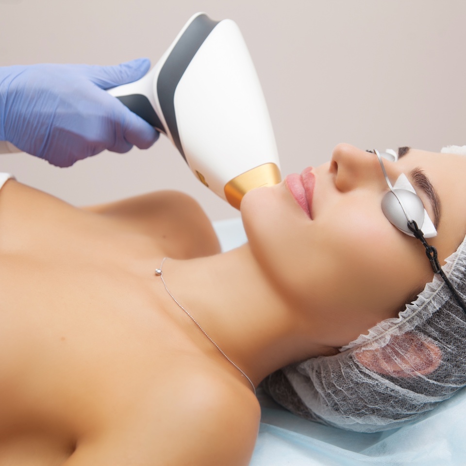 Anti-aging procedures. Skin care concept. Woman receiving facial beauty treatment, removing pigmentation at cosmetic clinic. Intense pulsed light therapy. IPL. Rejuvenation, photo facial therapy.