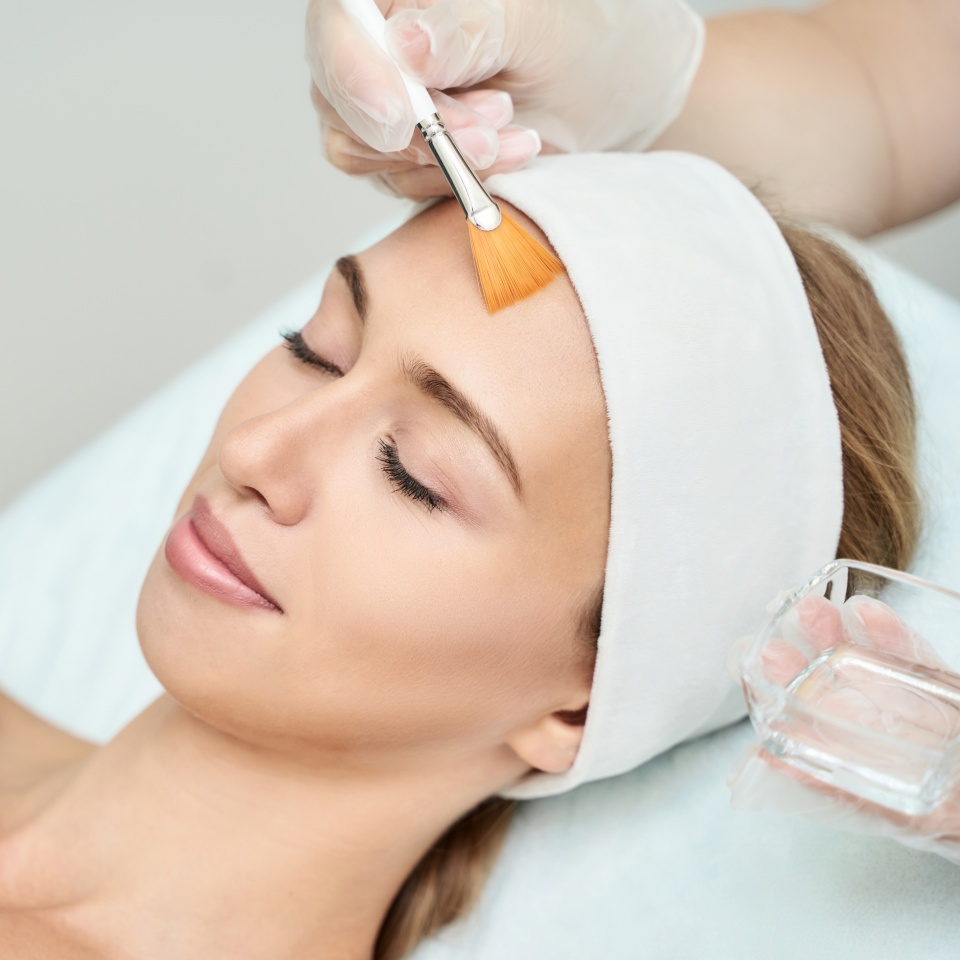 Cosmetology beauty procedure. Young woman skin care. Beautiful female person. Rejuvenation treatment. Facial chemical peel therapy. Clinical healthcare. Doctor hand. Dermatology cleanser.