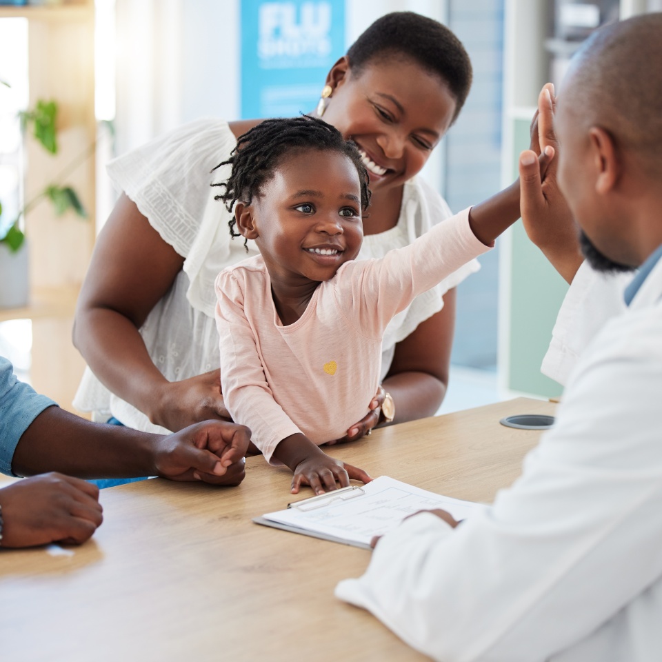 High five, doctor and family with a girl and her parents at the hospital for consulting, appointment and healthcare. Medicine, trust and support in a medical clinic with a health professional