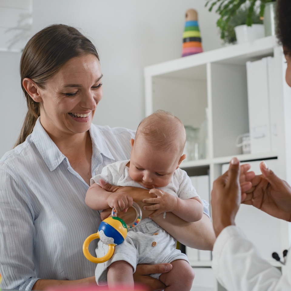 Appointment with a consultant pediatrician. Mother and baby at pediatricians office.