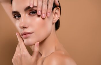 Close up photo of stunning model lady touch smooth perfect facial skin isolated on pastel color background